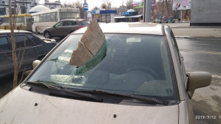 Возле цирка кусок фасада пробил лобовое стекло припаркованного автомобиля